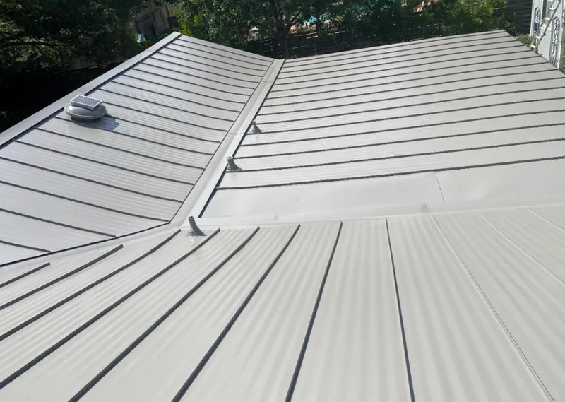 Solar attic fan installed on a metal roof for Roof Ventilation in Jefferson City